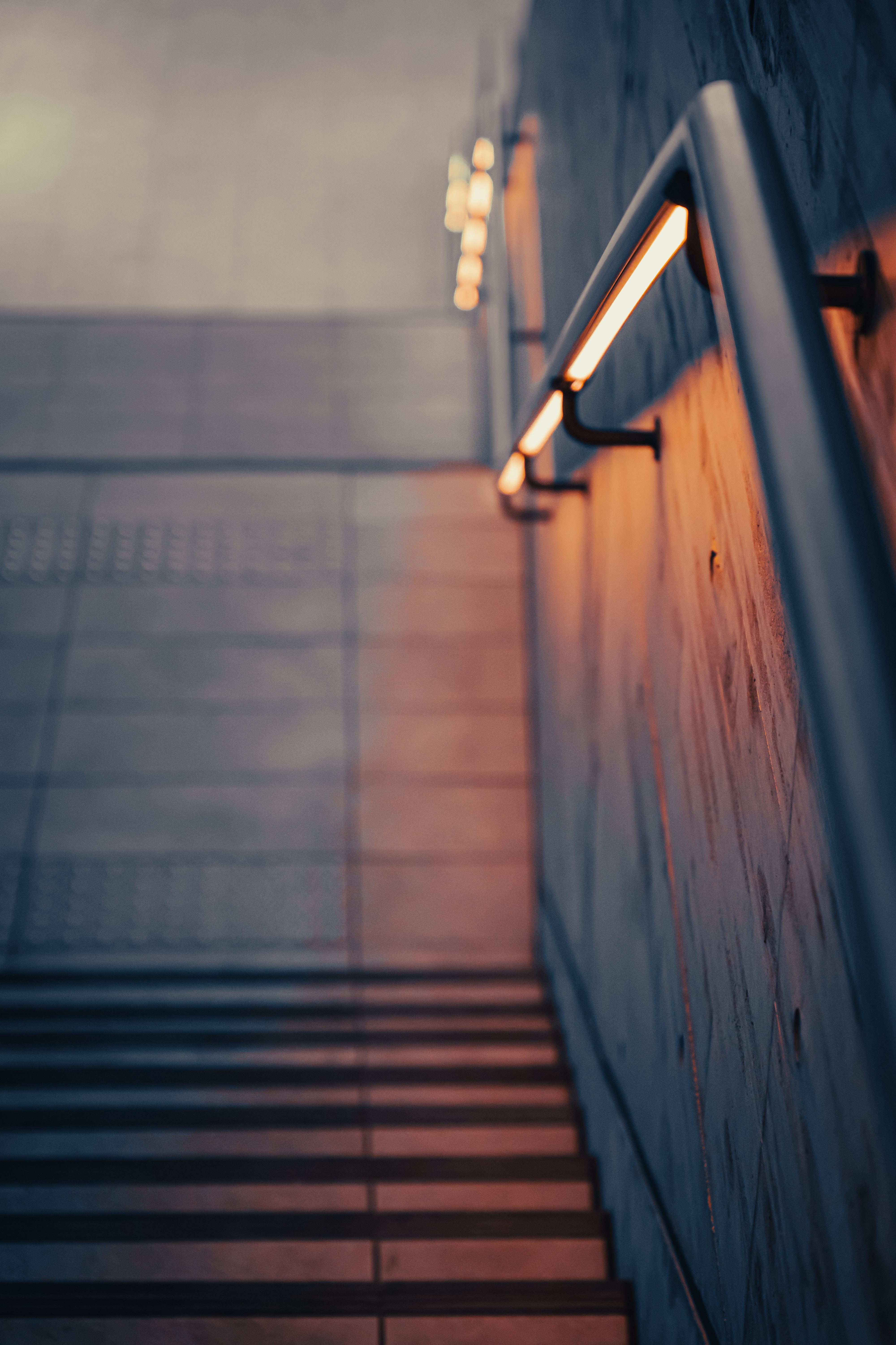 A person using a sturdy handrail while climbing stairs